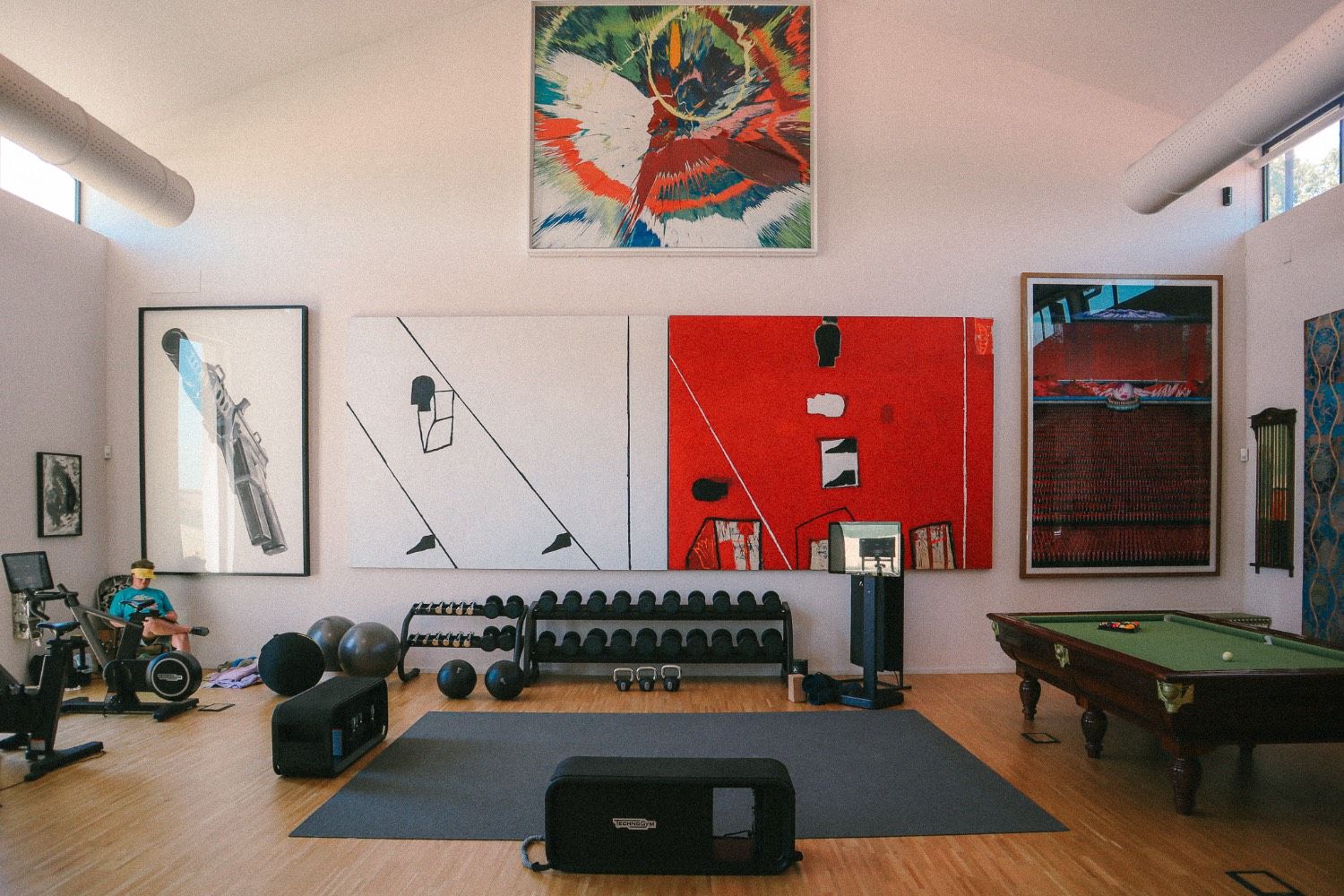 Home gym with modern art and a pool table