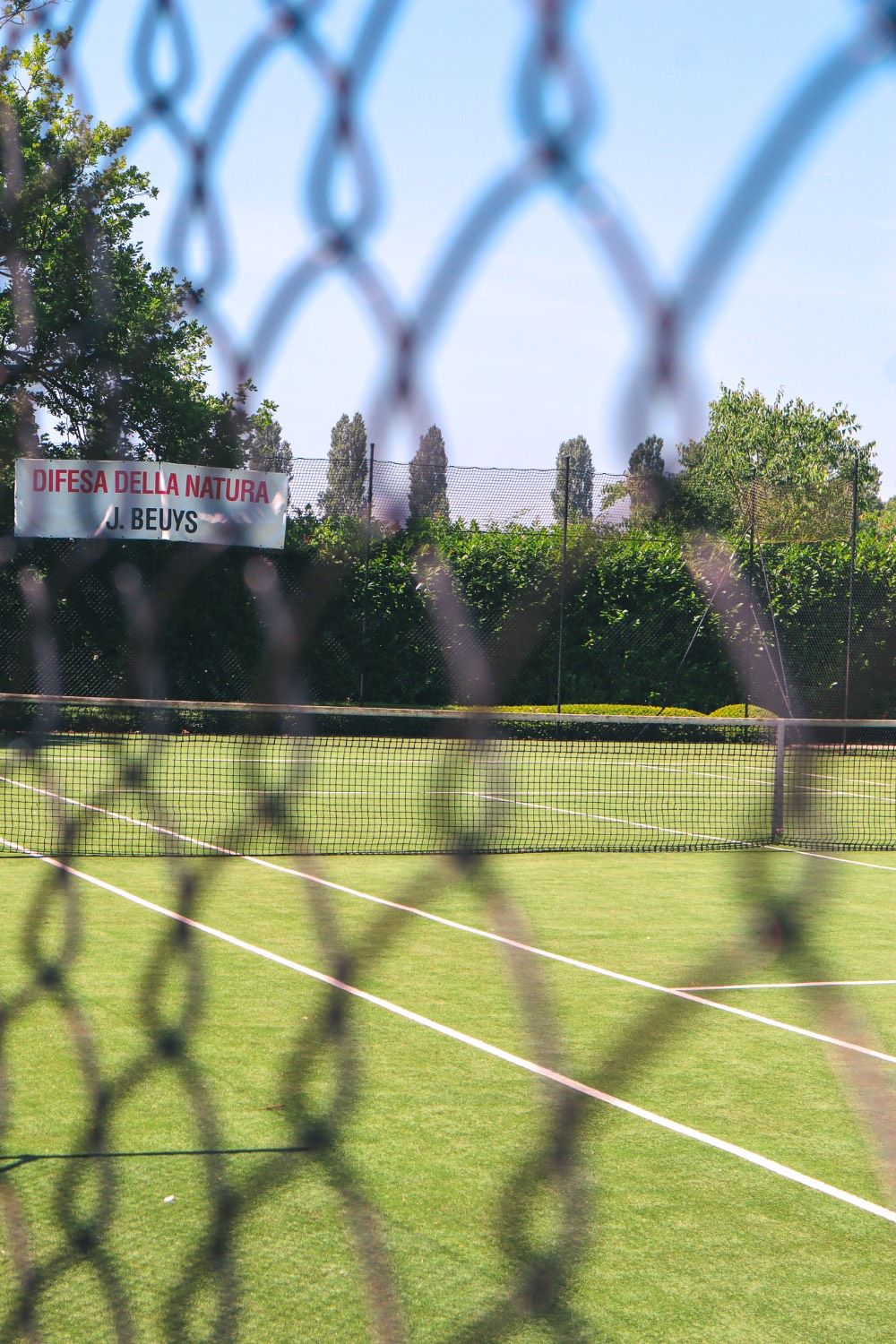 Tennis court seen through a chain-link fence